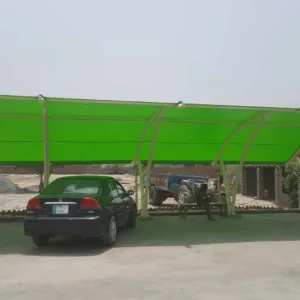 A beautiful modern car parking shade that covers the vehicle from direct sunlight and rain. The top membrane of PVC tensile fabric provides more strength to the base ms structure