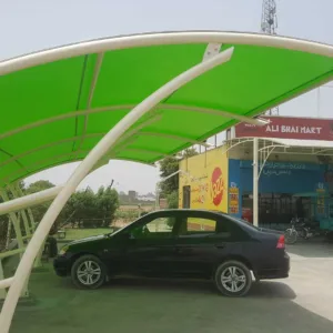 A beautiful modern car parking shade that covers the vehicle from direct sunlight and rain. The top membrane of PVC tensile fabric provides more strength to the base ms structure